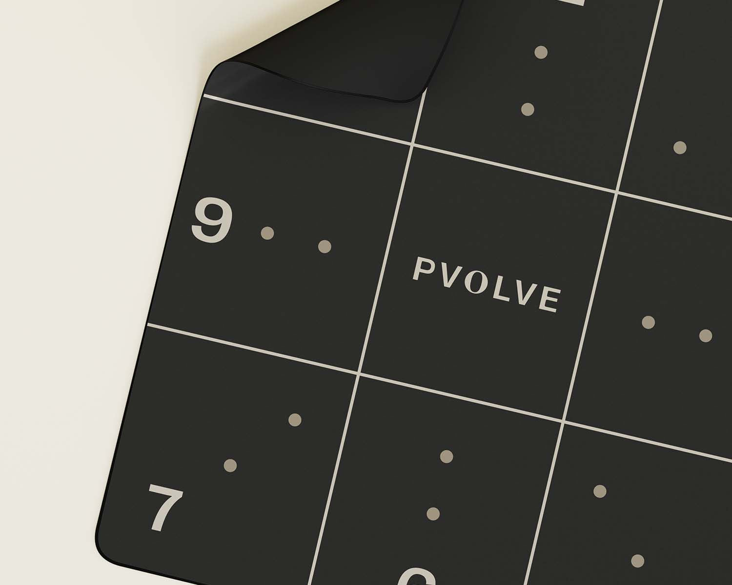 Black precision mat with grids and numbers, featuring an accompanying box.